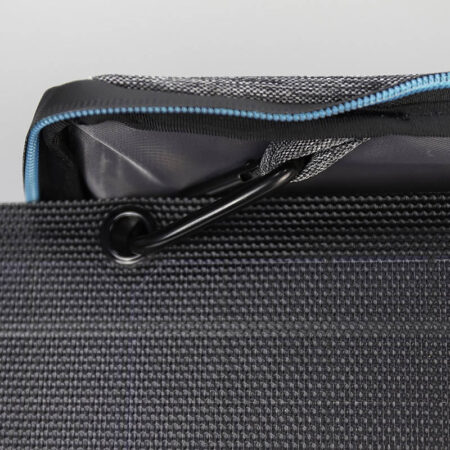 Durable black travel bag with internal organisation, featuring a close-up of a zipper and a black carabiner clip for outdoor gear. Perfect for off-grid adventures and eco-friendly living.