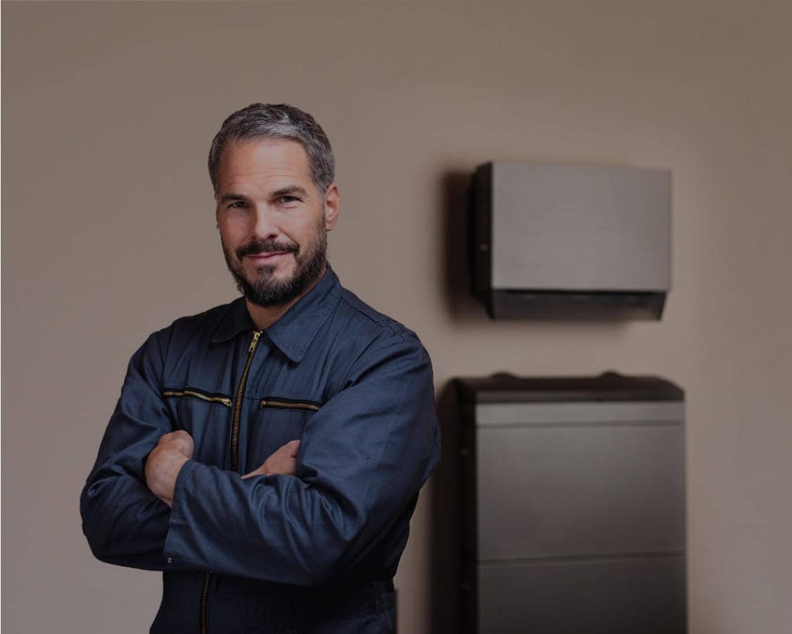 Eco-friendly man standing inside modern off-grid home with renewable energy solutions.