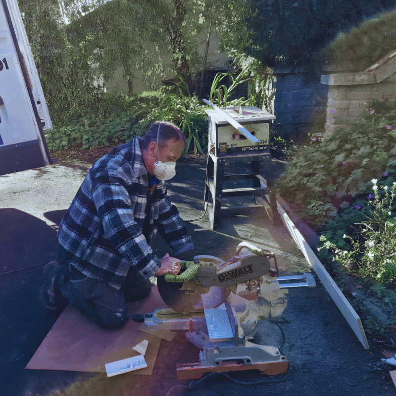 Irish tradesperson using a DeWalt saw outdoors powered by portable energy setup from Off Your Grid.